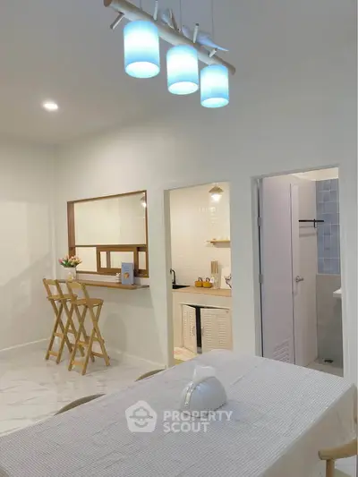 Modern open-layout kitchen with stylish lighting and dining area