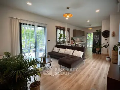 Spacious modern living room with open kitchen and garden view