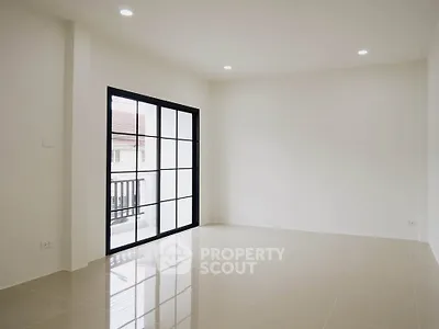 Spacious empty living room with large windows and glossy tiled floor