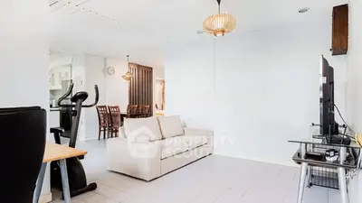 Spacious living room with modern decor and exercise equipment, perfect for relaxation and fitness.