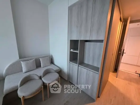 Modern living room with sleek furniture and built-in storage, perfect for urban living.