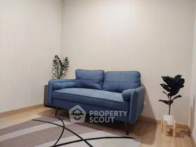 Cozy living room with stylish blue sofa and modern decor