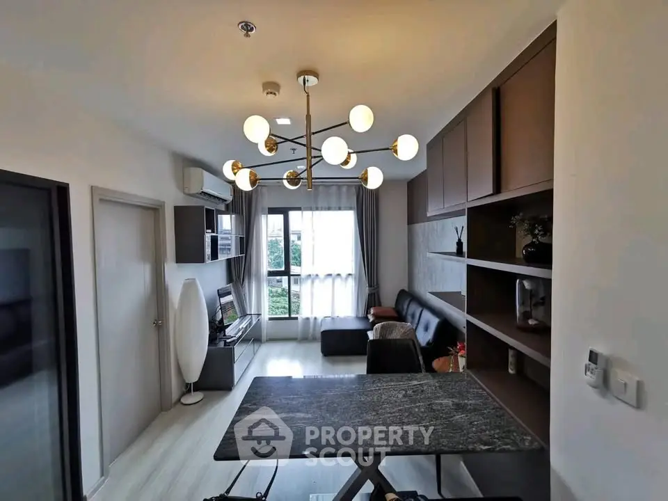 Modern living room with stylish lighting and sleek furniture in a contemporary apartment.