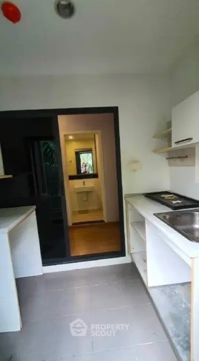 Modern kitchen with sleek design and open layout, featuring a sink and ample counter space.