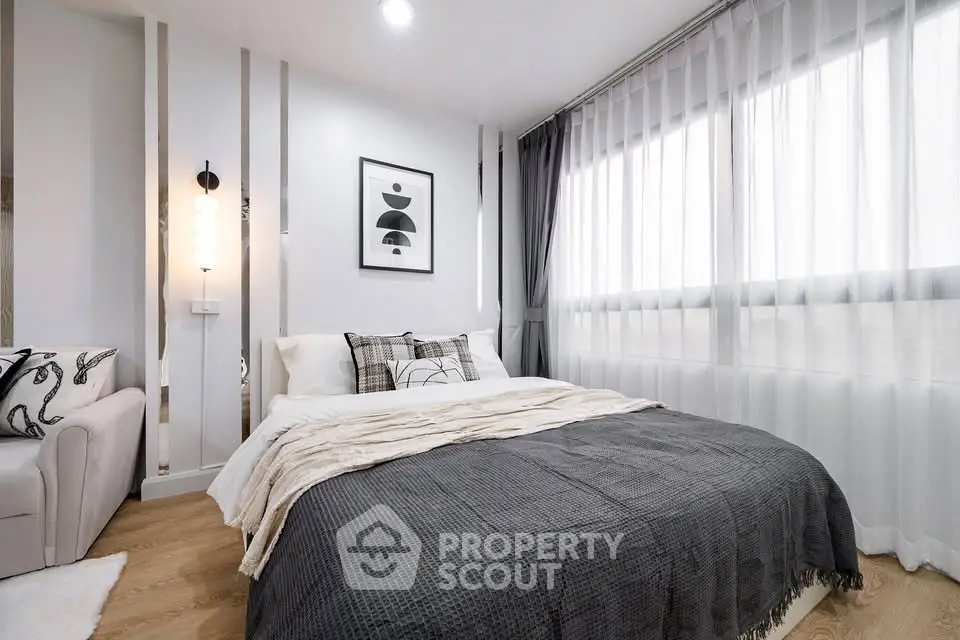 Modern bedroom with stylish decor and large window for natural light