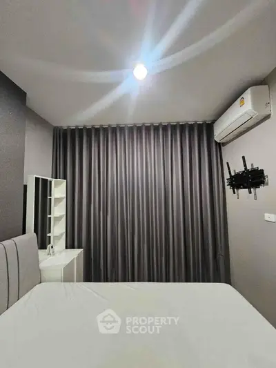 Modern bedroom with sleek design, featuring air conditioning and stylish curtains for a cozy ambiance.