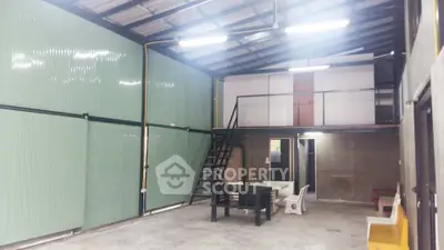 Spacious industrial-style interior with high ceilings and mezzanine level