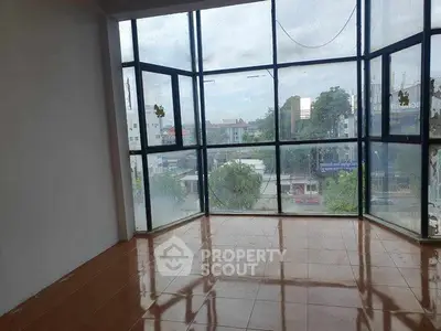 Spacious corner unit with large windows offering a panoramic city view, perfect for natural light lovers.