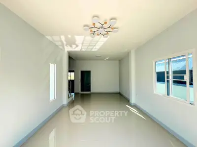 Spacious and bright living room with modern lighting and large windows