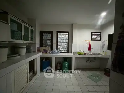 Spacious kitchen with tiled countertops and ample storage space