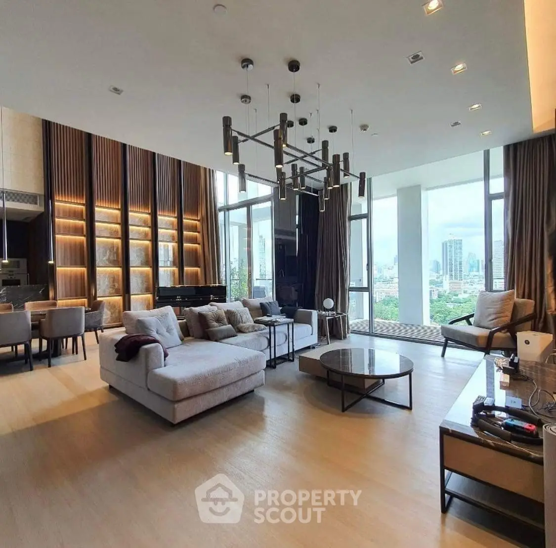 Luxurious living room with modern decor and stunning city view, featuring elegant lighting and spacious seating area.