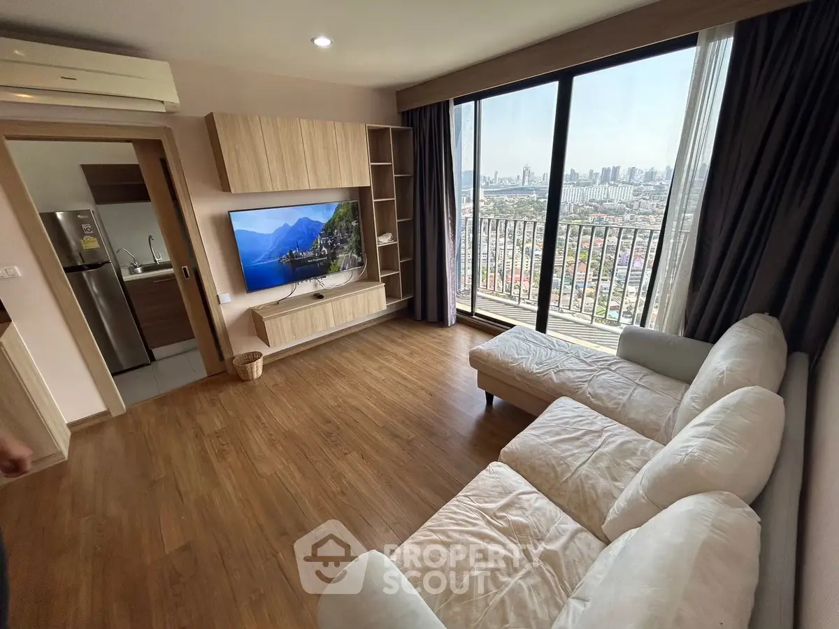 Modern living room with city view and large balcony in high-rise apartment