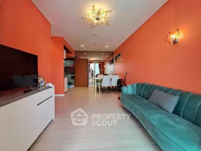 Modern living room with vibrant orange walls and stylish green sofa
