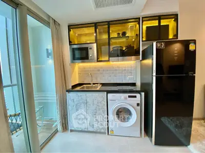 Modern kitchen with marble cabinets, washing machine, microwave, and balcony view.