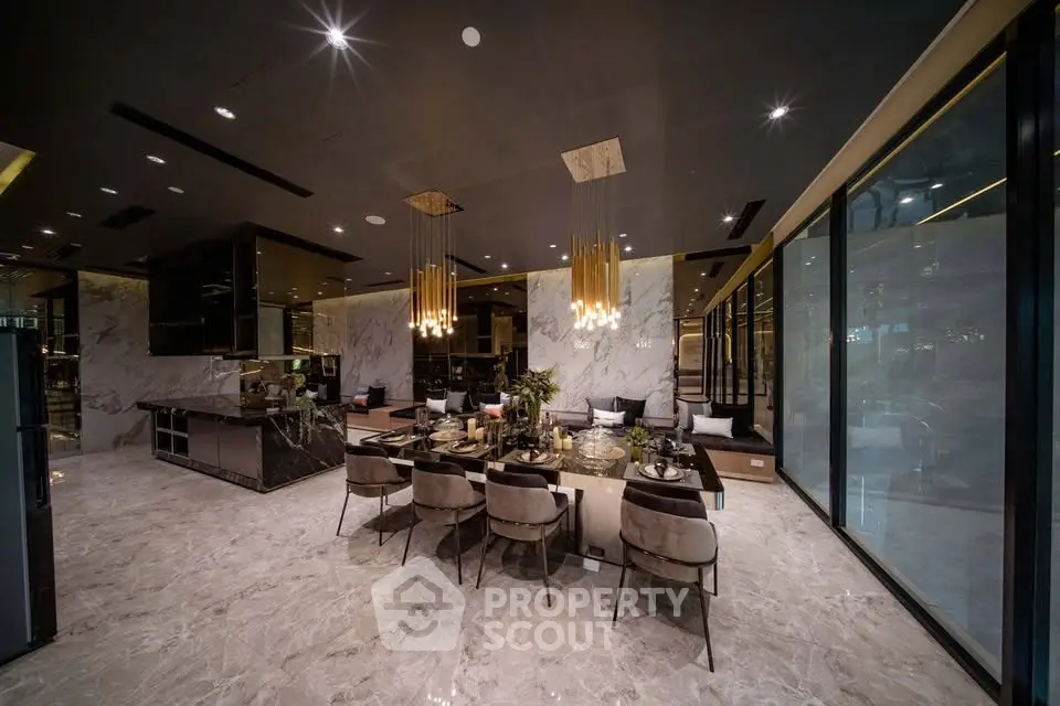 Luxurious open-plan dining area with elegant lighting and marble flooring in a modern apartment.