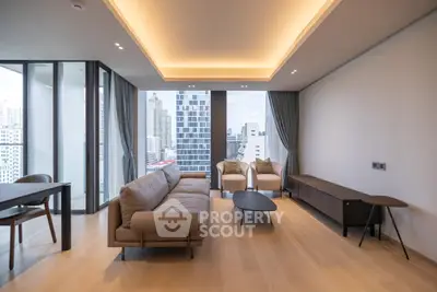 Modern living room with city view, featuring sleek furniture and floor-to-ceiling windows.