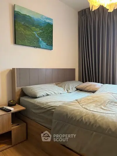 Cozy bedroom with modern decor and natural light, featuring a comfortable bed and elegant curtains.