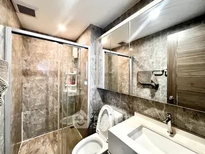 Modern bathroom with glass shower and sleek fixtures