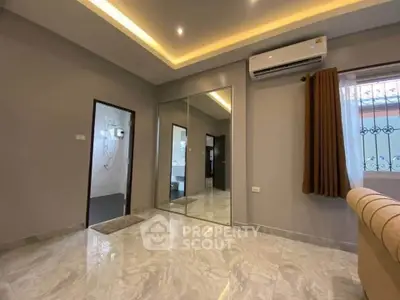 Modern living room with marble flooring and mirrored closet doors