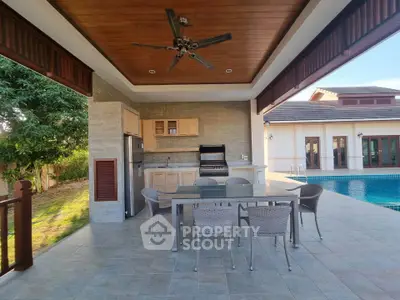 Luxurious outdoor patio with dining area and poolside view