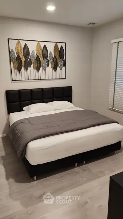 Modern bedroom with stylish decor and comfortable bed in a contemporary home.
