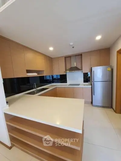 Modern kitchen with sleek cabinetry and stainless steel appliances in a spacious open layout.