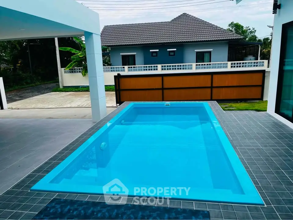 Modern home with sleek pool and spacious patio, perfect for relaxation and entertainment.