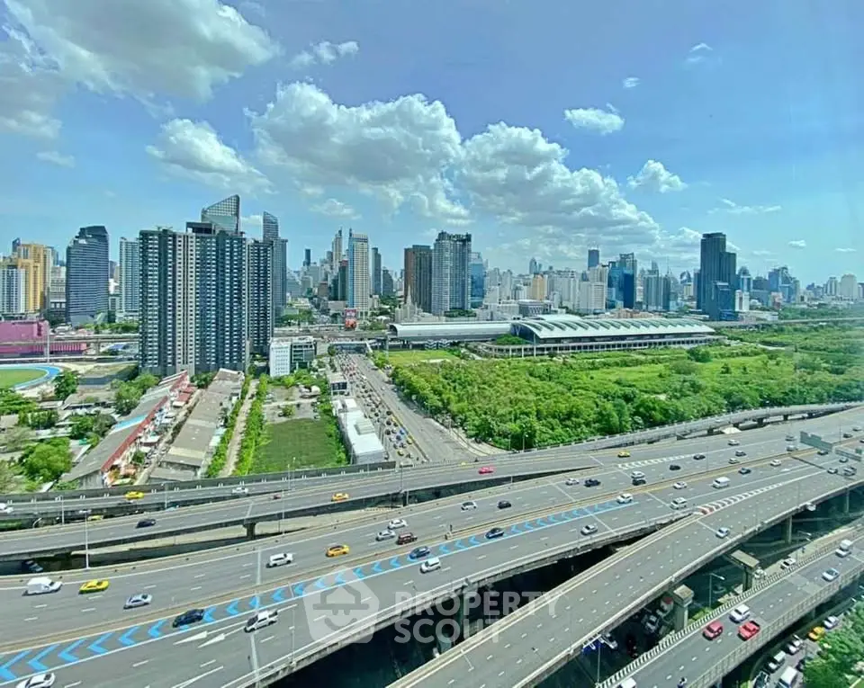 Stunning cityscape view with modern skyscrapers and highways under a clear blue sky.