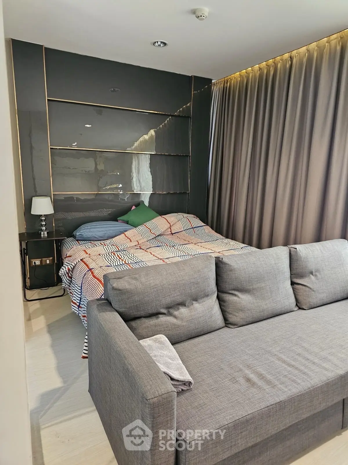 Modern bedroom with stylish decor and cozy sofa in a chic apartment
