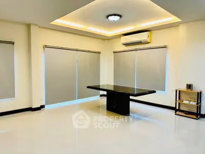 Spacious modern living room with sleek table and ambient lighting