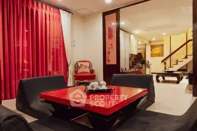 Stylish living room with red accents and modern furniture, perfect for entertaining guests.