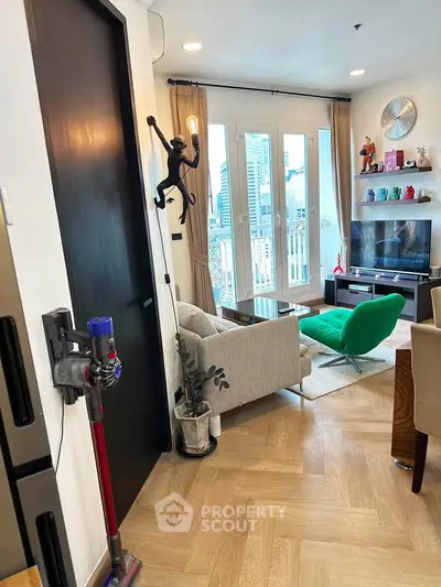 Modern living room with stylish decor and city view, featuring a cozy seating area and entertainment setup.