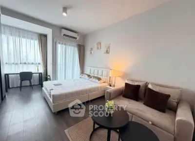 Modern studio apartment with cozy living area and stylish decor