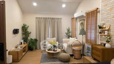 Cozy living room with modern decor, featuring a comfortable sofa, stylish coffee table, and elegant lighting.