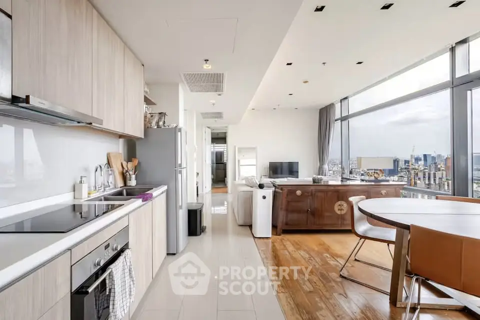 Modern open-layout kitchen and living room with city view in luxury apartment