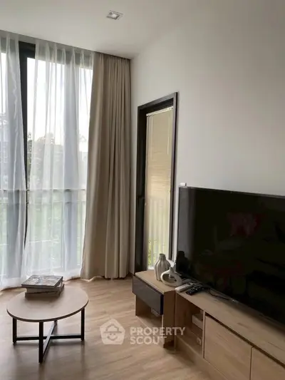 Modern living room with large window and stylish furniture