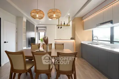 Modern dining area with elegant wooden furniture and stylish lighting in a contemporary home.