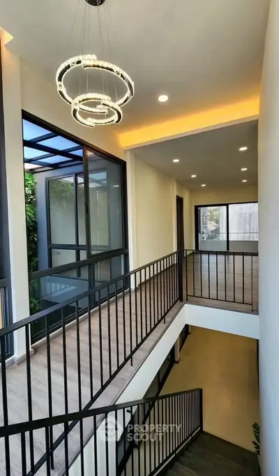 Modern interior staircase with sleek railing and stylish lighting in a contemporary home.