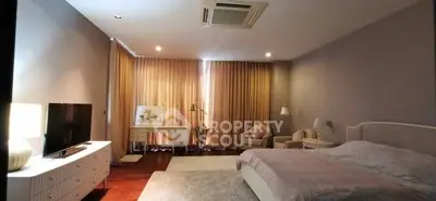 Spacious bedroom with elegant decor and natural light