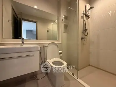 Modern bathroom with sleek fixtures and glass shower enclosure