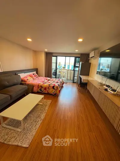 Spacious studio apartment with modern decor and balcony view