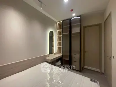 Modern bedroom with built-in wardrobe and stylish lighting