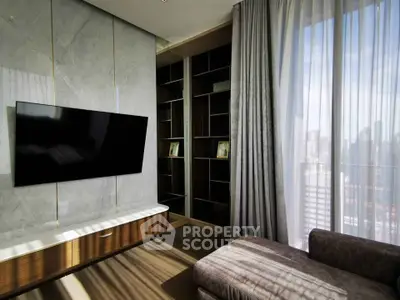Luxurious living room with modern TV setup and floor-to-ceiling windows offering city views.