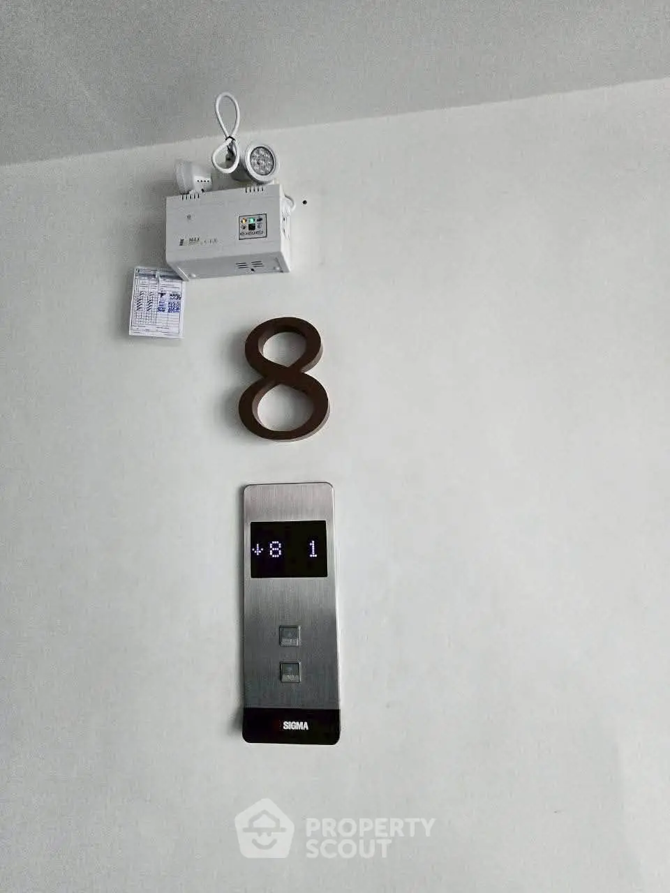 Modern elevator floor indicator on a minimalist wall in a contemporary building.