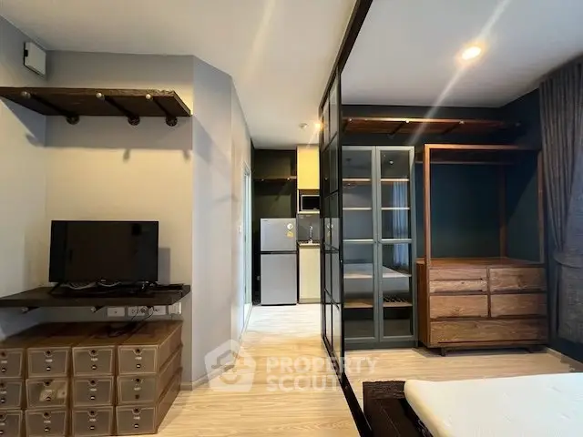 Modern studio apartment with sleek glass partitions and stylish wooden furniture.