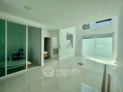 Spacious modern interior with large windows and sleek tile flooring