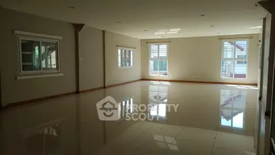 Spacious empty room with large windows and glossy tiled floor