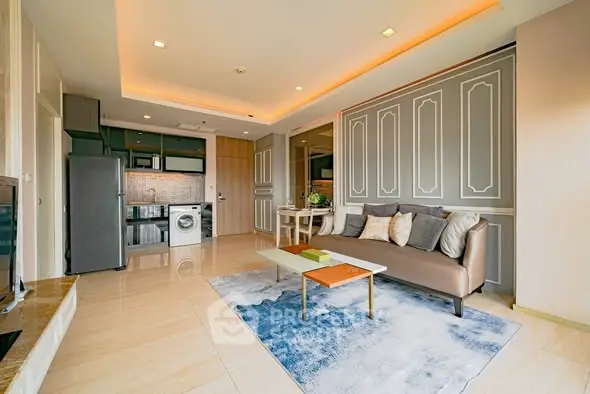 Modern living room with stylish decor and integrated kitchen appliances.