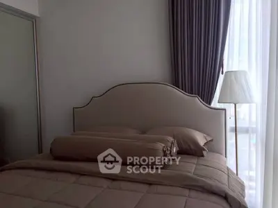 Cozy bedroom with elegant headboard and soft lighting, perfect for relaxation.