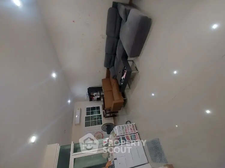 Spacious living room with modern furniture and bright lighting